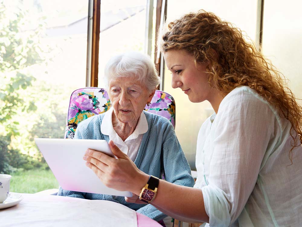 Grandma and granddaughter making an online wish list