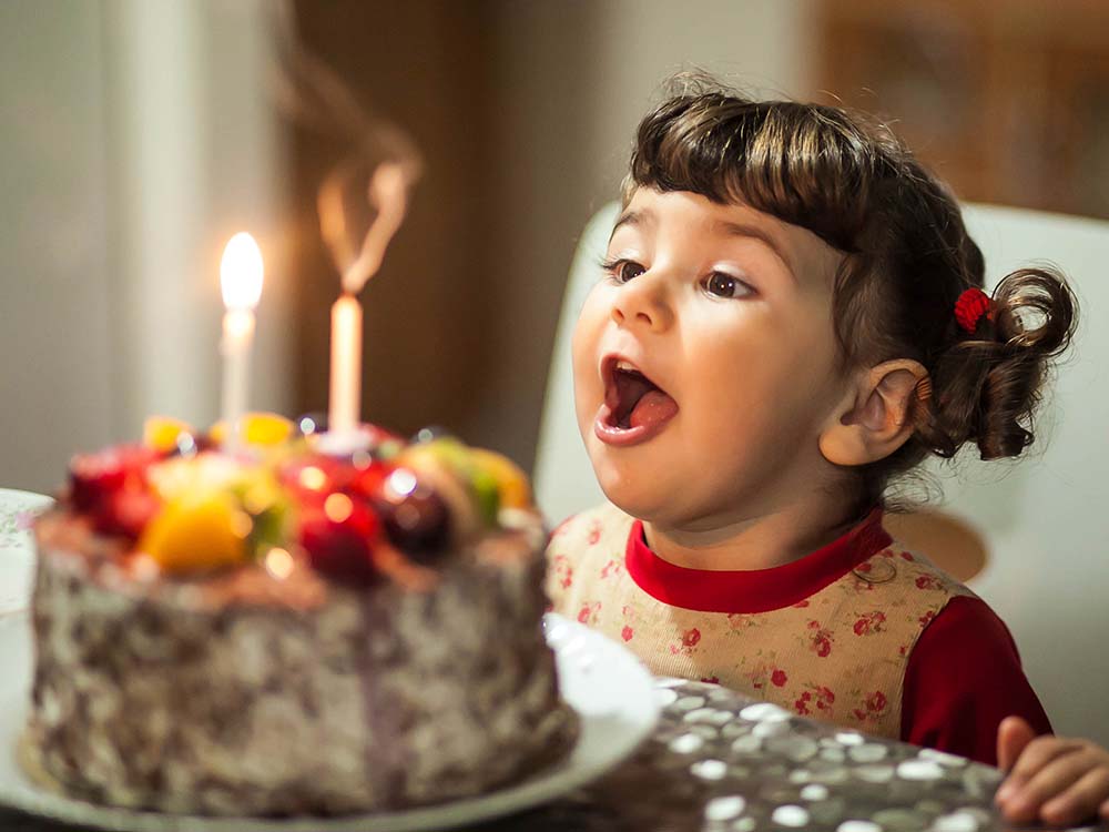 Girl blowing out birthday candles