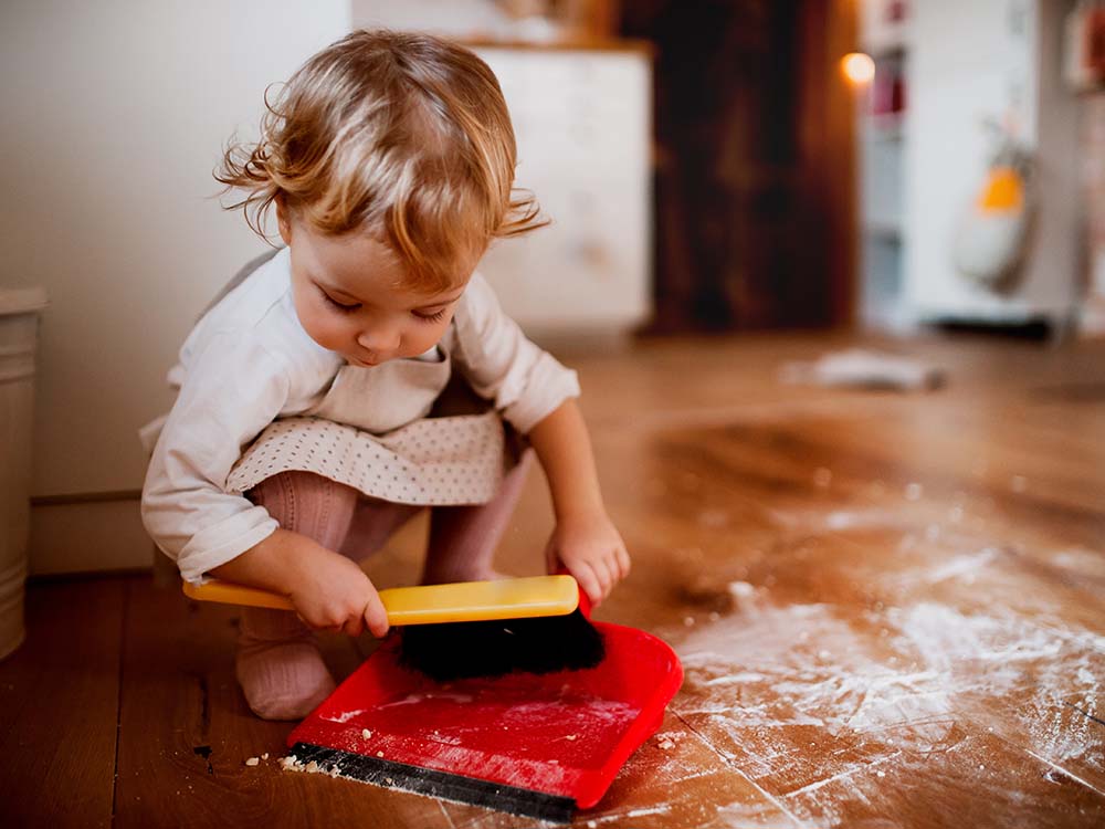 Girl sweeping floor